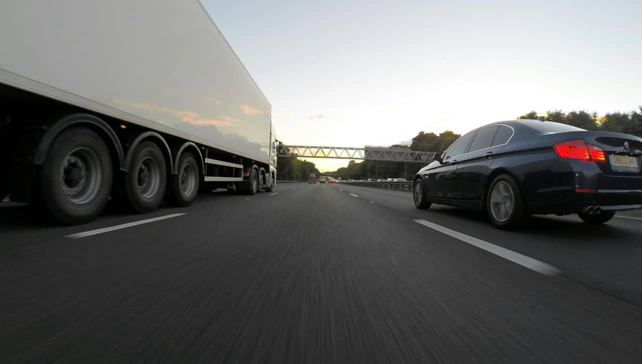 A truck and car on the highway